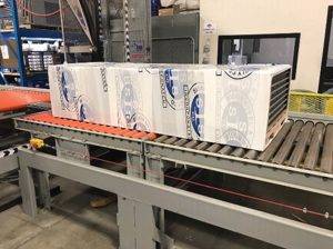TAB custom branded stretch wrap on roller conveyor TAB Wrapper Tornado